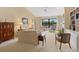 Living room with fireplace, built in bookcases, and lake view at 7323 Oak Moss Dr # 42, Sarasota, FL 34241