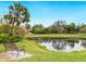 Serene pond-side bench, lush landscaping, and palm trees create a relaxing community atmosphere at 7323 Oak Moss Dr # 42, Sarasota, FL 34241