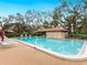 Inviting community pool with lounge chairs and covered seating area at 7323 Oak Moss Dr # 42, Sarasota, FL 34241