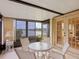Bright sunroom with lake view, table and chairs, and access to the backyard at 7323 Oak Moss Dr # 42, Sarasota, FL 34241