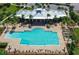 Aerial view of community pool, clubhouse, and surrounding landscape at 931 Mangrove Edge Ct, Bradenton, FL 34208