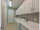 Laundry room with white cabinets, washer, dryer, and built-in sink at 931 Mangrove Edge Ct, Bradenton, FL 34208