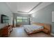 Spacious main bedroom with large windows, wood flooring and a modern bed at 931 Mangrove Edge Ct, Bradenton, FL 34208