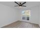 Spacious bedroom with wood-look flooring and a ceiling fan at 9481 Highland Oak Dr # 310, Tampa, FL 33647