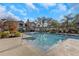 Community pool with lounge chairs and landscaping at 9481 Highland Oak Dr # 310, Tampa, FL 33647