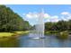 Water fountain in a canal with lush landscaping at 1015 Calico Gln, Bradenton, FL 34212