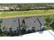 Aerial view of condo building, showing roofline and landscaping at 1100 Capri Isles Blvd # 522, Venice, FL 34292