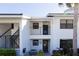 White exterior of condo building with dark accents and balcony at 1100 Capri Isles Blvd # 522, Venice, FL 34292