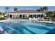 Inviting community pool with lounge chairs and patio at 1100 Capri Isles Blvd # 522, Venice, FL 34292