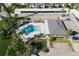 Aerial view of community pool, clubhouse, and parking at 1100 Capri Isles Blvd # 522, Venice, FL 34292