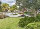 Landscaped area with bike rack and seating near a pond at 11608 Little River Way, Parrish, FL 34219