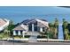 Waterfront property showcasing a contemporary home with a private walkway and lush landscaping at 1206 Blue Shell Loop, Sarasota, FL 34240