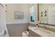 Modern bathroom with a sink, toilet, and stylish wall decor at 1206 Blue Shell Loop, Sarasota, FL 34240