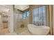 Bathroom with freestanding tub and glass shower at 1206 Blue Shell Loop, Sarasota, FL 34240