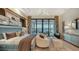 Elegant primary bedroom with sitting area and lake view at 1206 Blue Shell Loop, Sarasota, FL 34240