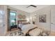 Bright bedroom with a queen-size bed, nightstands, and a large window at 1206 Blue Shell Loop, Sarasota, FL 34240