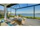 Relaxing covered patio with fire pit and lake view at 1206 Blue Shell Loop, Sarasota, FL 34240
