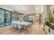 Elegant dining room with light wood floors and modern light fixture at 1206 Blue Shell Loop, Sarasota, FL 34240