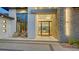 Elegant entryway with a stone wall, modern lighting, and glass doors at 1206 Blue Shell Loop, Sarasota, FL 34240