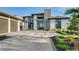 Modern home with a stone facade, two-car garage, and manicured landscaping at 1206 Blue Shell Loop, Sarasota, FL 34240