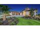 Modern house exterior with landscaped yard and three-car garage at 1206 Blue Shell Loop, Sarasota, FL 34240