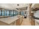 Modern kitchen with island, stainless steel appliances, and water views at 1206 Blue Shell Loop, Sarasota, FL 34240