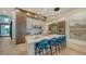Modern kitchen island with seating and quartz countertop at 1206 Blue Shell Loop, Sarasota, FL 34240