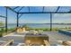 Relaxing lanai with fire pit overlooking lake at 1206 Blue Shell Loop, Sarasota, FL 34240
