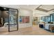 Open living area with glass partition and modern decor at 1206 Blue Shell Loop, Sarasota, FL 34240