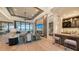 Spacious living room with fireplace, water views, and modern furniture at 1206 Blue Shell Loop, Sarasota, FL 34240