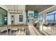 Outdoor kitchen with built-in grill, bar seating, and dining area, overlooking the water at 1206 Blue Shell Loop, Sarasota, FL 34240
