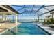Relaxing pool area with a screened enclosure, offering stunning lake views at 1206 Blue Shell Loop, Sarasota, FL 34240