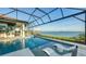 Resort-style pool and outdoor kitchen with a lake view and screened lanai at 1206 Blue Shell Loop, Sarasota, FL 34240