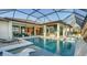 Luxury pool and spa with outdoor kitchen and lake view at 1206 Blue Shell Loop, Sarasota, FL 34240