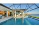 Resort-style pool with outdoor kitchen and dining area at 1206 Blue Shell Loop, Sarasota, FL 34240
