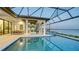 Luxury pool and spa with outdoor kitchen and dining area at 1206 Blue Shell Loop, Sarasota, FL 34240