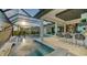 Luxury pool area with a spa, outdoor kitchen, and lake views at 1206 Blue Shell Loop, Sarasota, FL 34240