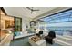 Covered patio overlooking the pool and lake, featuring comfortable seating at 1206 Blue Shell Loop, Sarasota, FL 34240