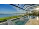 Inviting pool and spa with a screened enclosure and lake views at 1206 Blue Shell Loop, Sarasota, FL 34240