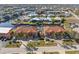 Aerial view of two-story townhouses with water access, garages, and lush landscaping at 1323 Mediterranean Dr # 111, Punta Gorda, FL 33950