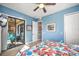 Bright bedroom with sliding glass doors leading to a patio, and a walk-in closet at 1323 Mediterranean Dr # 111, Punta Gorda, FL 33950