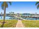 Brick-paved pathway to boat lift, canal and homes in background at 1323 Mediterranean Dr # 111, Punta Gorda, FL 33950