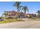 Two story building with attached garages and palm trees at 1323 Mediterranean Dr # 111, Punta Gorda, FL 33950