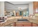 Kitchen with granite countertops, sink, and view into the living area at 1323 Mediterranean Dr # 111, Punta Gorda, FL 33950
