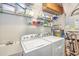 Laundry room with washer, dryer, and ample shelving for storage at 1323 Mediterranean Dr # 111, Punta Gorda, FL 33950