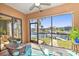 Relaxing screened porch overlooking canal with boat at 1323 Mediterranean Dr # 111, Punta Gorda, FL 33950