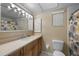Clean bathroom with light wood vanity, a toilet, and a shower/tub combo at 1348 Westport Ln # 1405, Sarasota, FL 34232