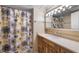 Clean bathroom with a shower/tub combo and wood vanity at 1348 Westport Ln # 1405, Sarasota, FL 34232