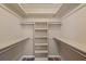 Spacious walk-in closet with shelving and hanging rods at 1348 Westport Ln # 1405, Sarasota, FL 34232