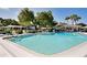 Community pool with lounge chairs and shaded seating at 1348 Westport Ln # 1405, Sarasota, FL 34232